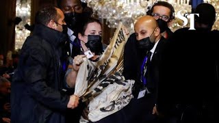Climate protestor storms Louis Vuitton catwalk