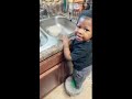 Semaj washing dishes
