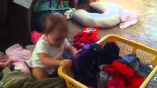 Baby helps with laundry