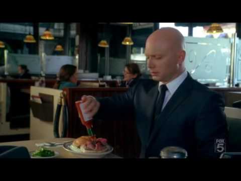 The Observer eating a burger