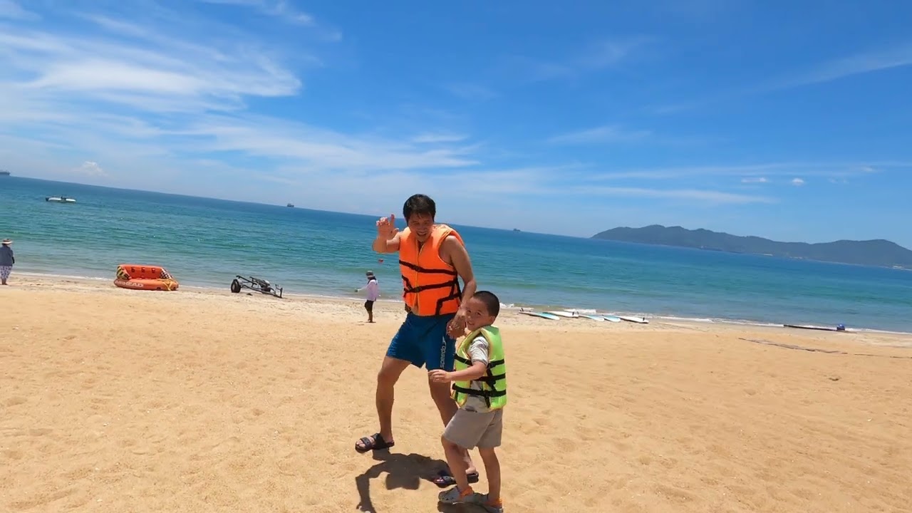 Visitors enjoy crystal-clear waters of Lang Co Beach.