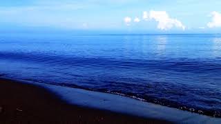 Calm Blue Light Beach Waves in the Sunny Morning Light