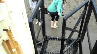 Climbing onto the lighthouse, Beth, Colleen and Matt.