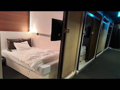 , title : 'Japanese airport capsule hotel with a secret base feel| First Cabin Haneda'