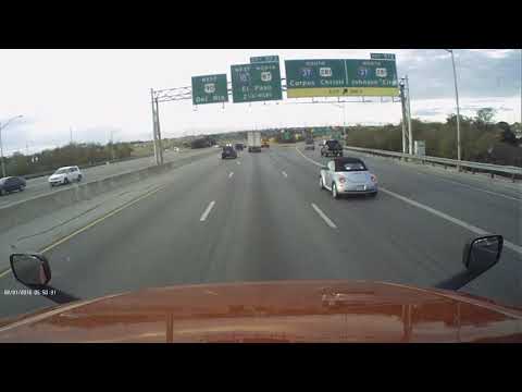 Watch a semi truck and school bus duel on a Texas interstate