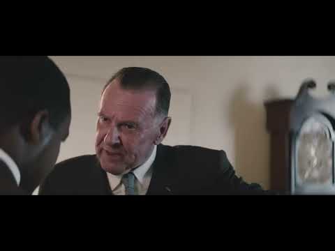 Selma official trailer frame: marchers on the Edmund Pettus Bridge under bright daylight