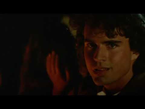 The Lost Boys trailer frame of Michael and Star together, lit by neon, with music pulsing