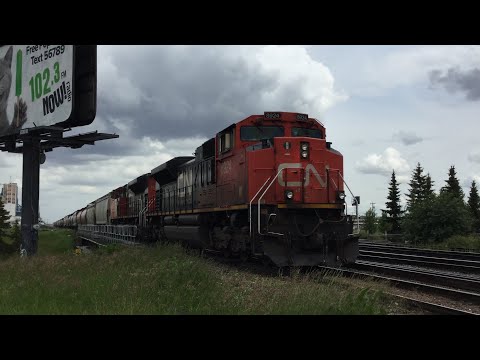 Two CN SD70M-2's Lead a CN Grain Train In The Rain!