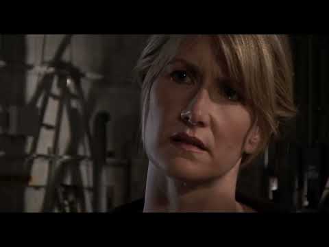 Official trailer frame: Laura Dern in fractured close-up under harsh light, a drone building beneath