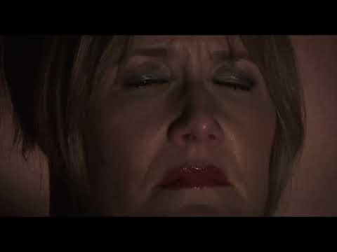 Trailer collage: strobing stage light, close-up eyes, a corridor; music jumps from croon to siren