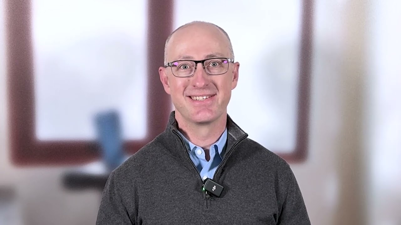 Dr. Thomas Semrad, medical oncologist and hematologist, sitting in front of blurred windows