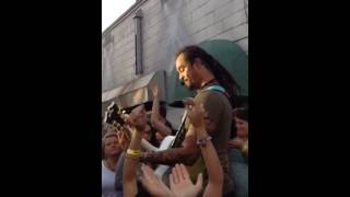 Michael Franti sings "Love will find a way" in the crowd
