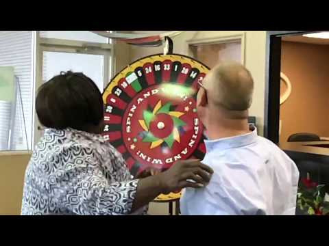 Katina spinning the Prize Wheel to win a trip to Cuba!