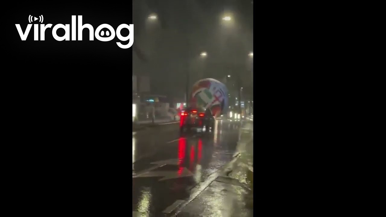 Giant World Cup Inflatable Ball Rolls Through Streets Amid Inclement Weather || ViralHog