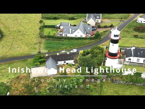 Flying over Inishowen Head Lighthouse on a rainy day, County Donegal, Ireland