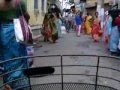 A YOUNG LADY CYCLING ON LOCAL MARKET