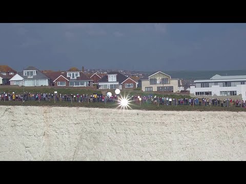 Hundreds gathered with mirrors to flash 'SOS signal' to Europe