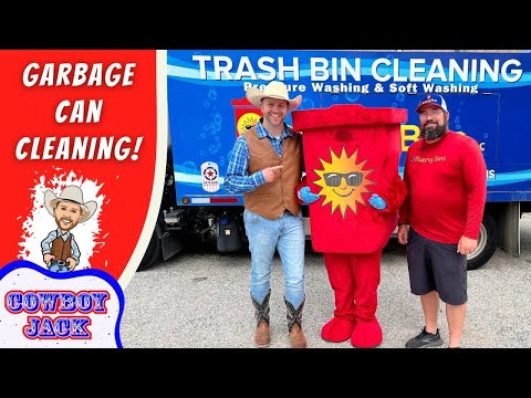 Promo photo for garbage can cleaning service with two men in western outfits posing with a red sun-logo trash can mascot in front of a blue Trash Bin Cleaning truck, promoting the service.