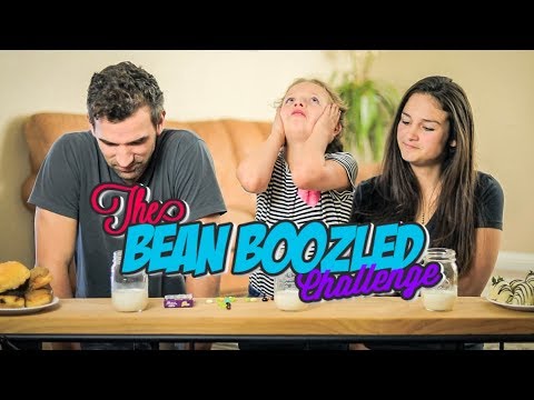 Three people sit at a table for a Bean Boozled Challenge; a girl in striped shirt looks stressed, while a man and a woman watch. Milk and jelly beans on the table are visible.