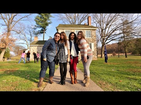 Students posing infront of log cabin at Valley Forge