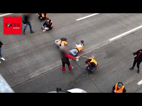 Autofahrer treten Klima-Kleber und bespritzen sie mit Flüssigkeiten