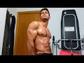 Young bodybuilder flexing muscles after workout