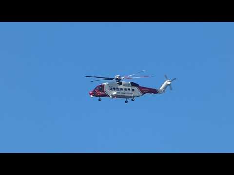 Coastguard Rescue Helicopter flies above Llanfairfechan Wales UK 26.9.18