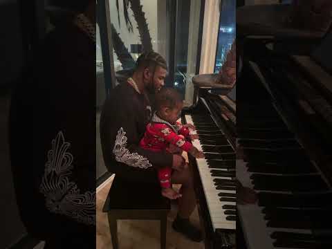 Shilo teaching Snow how to play  the piano.