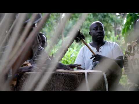 Albert Bisaso Ssempeke with his Buganda Music Ensemble performing in looting village