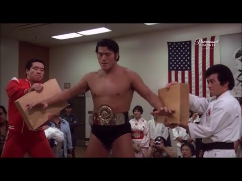 Antonio Inoki breaks wooden boards with his hands and head