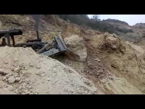 Pushing huge boulder off hill!