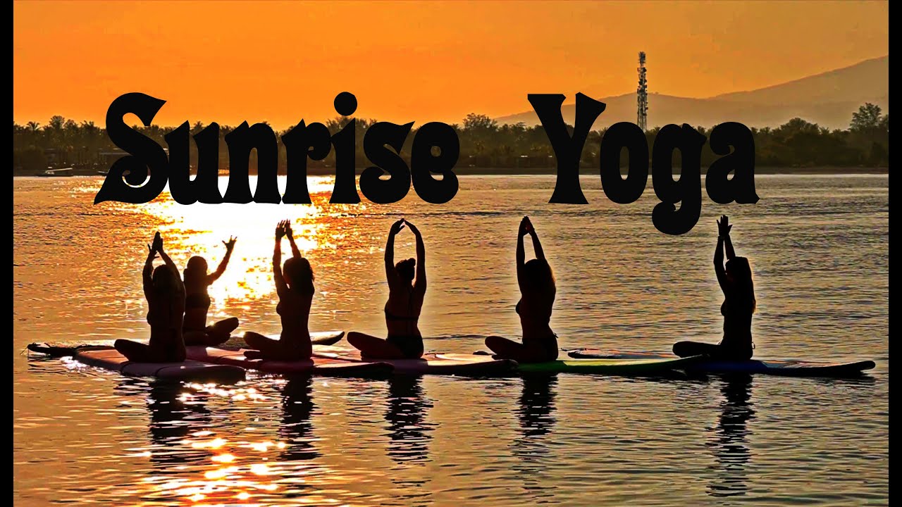 Experience the enchanting visuals of a Sunrise Stand-Up Paddleboard Yoga Session.