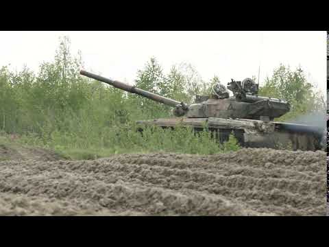 military tank in movement on a dirt ground terrain aerial