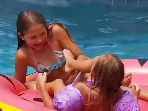 4 girls wrestle on a pool float in slow motion [4K]