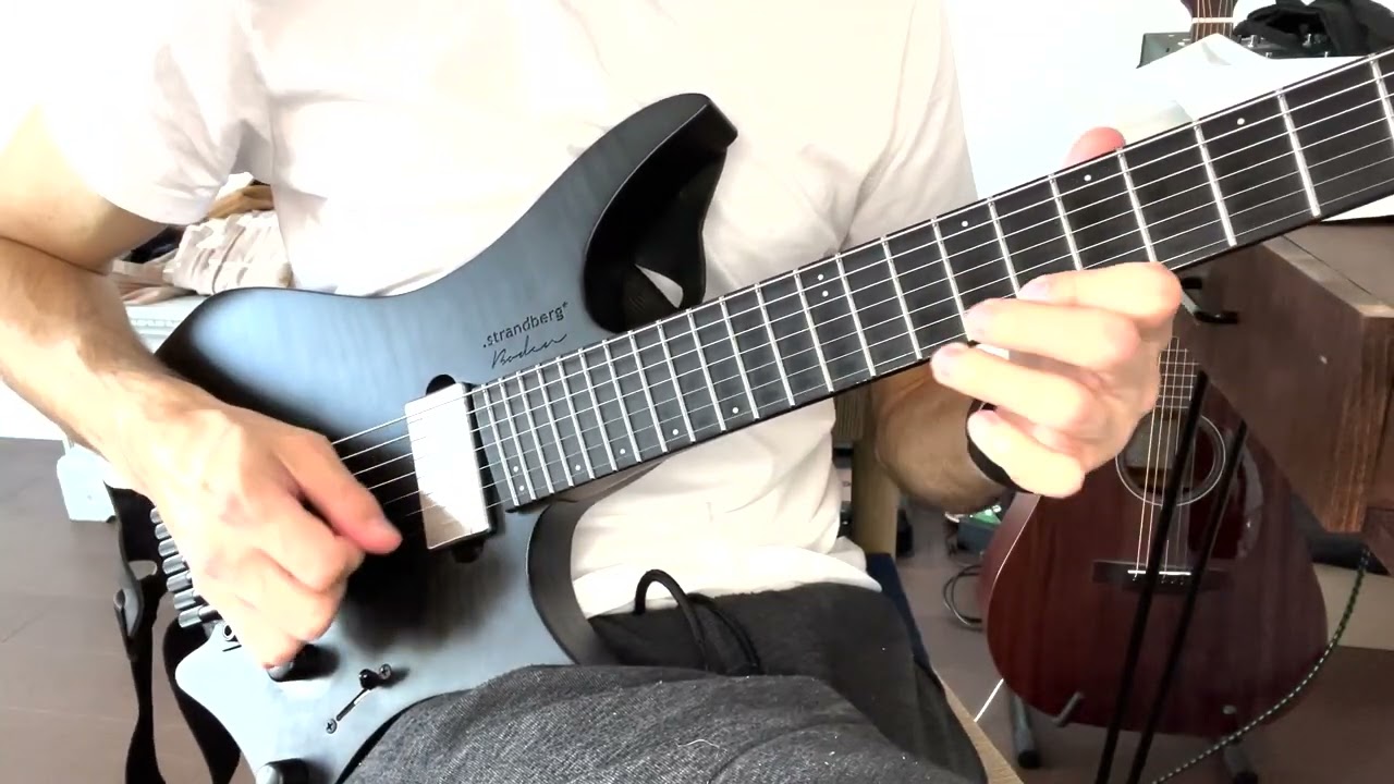 Guitarist playing a string skipping pentatonic lick, picking hand jumping over a muted middle string.