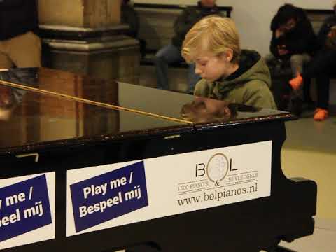 Amsterdam Centraal 2: A boy plays the piano at the train station on New Year's Eve 2019