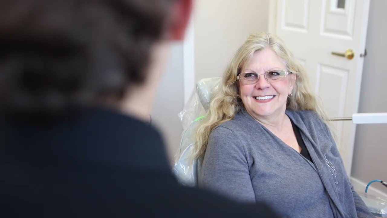 Woman in dental chair smiling at her Orem dentist