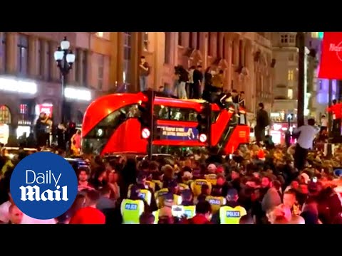 Ecstatic England fans jump on roof of London bus after Denmark Euro 2020 win