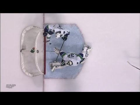 Kevin Bieksa kicks flying puck to save a goal