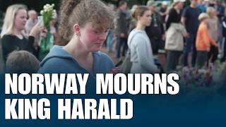 Tearful Norwegians Bid Final Goodbye To King Harald, lay flowers outside royal palace
