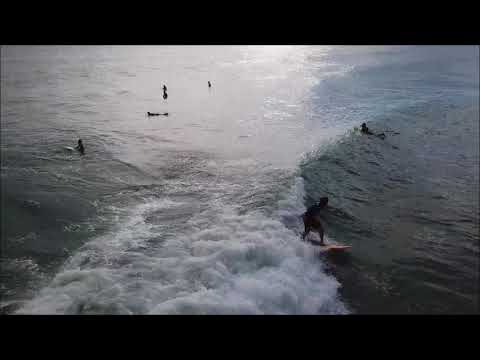 Surfers and fun waves captured by drone at Pelican Beach Park