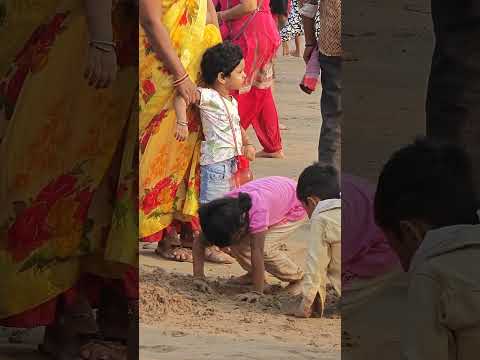 Cute little girl playing in the beach sand, juhu beach