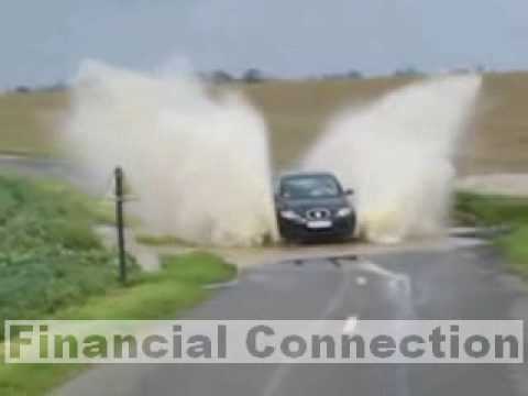 Big water splash with car on flooded road after rains