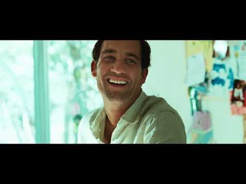 Trailer montage: sunlit kitchen, coastal road, and backyard chaos underscored by guitar motifs