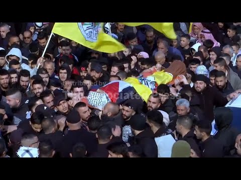 Mourners line the streets of Tuqu' for the funeral of a 16 year-old boy killed by Israeli soldiers