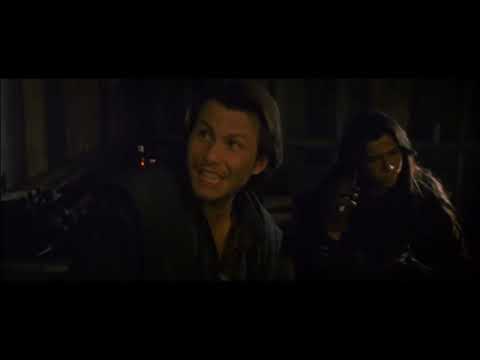 Trailer still: close-up of Billy the Kid aiming a revolver against twilight sky