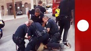 "He's just a kid!" Onlookers horrified as 9 police arrest teen for 'jaywalking'