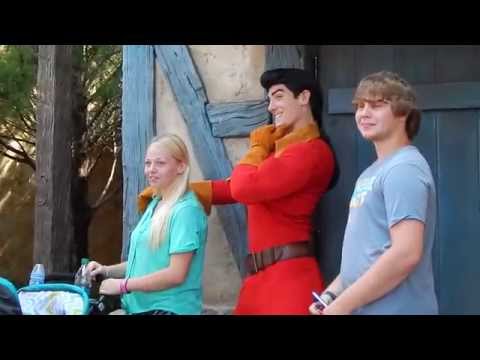 Belle grabs a book from GASTON at Disney World Magic Kingdom