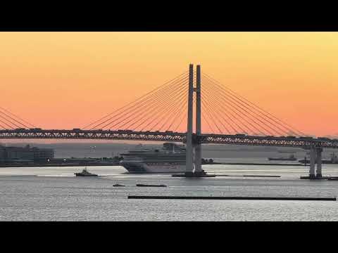 Thumbnail for Watch as Diamond Princess Cruise Ship Narrowly Passes Under Yokohama Bay Bridge with Sunrise lit Sky