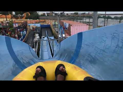 Sliding down Southend-On-Sea Adventure Island’s blue water slide with an inflatable raft